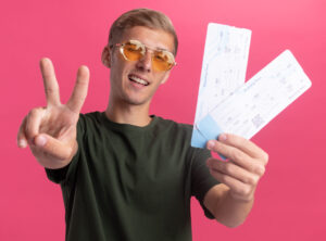 junger Mann mit 2 Eintrittskarten